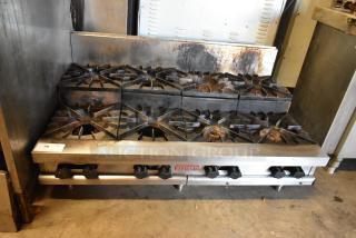 Vulcan commercial gas range, stainless steel, 2-tier, 8 burners, good condition, visible wear. Model label: Vulcan.