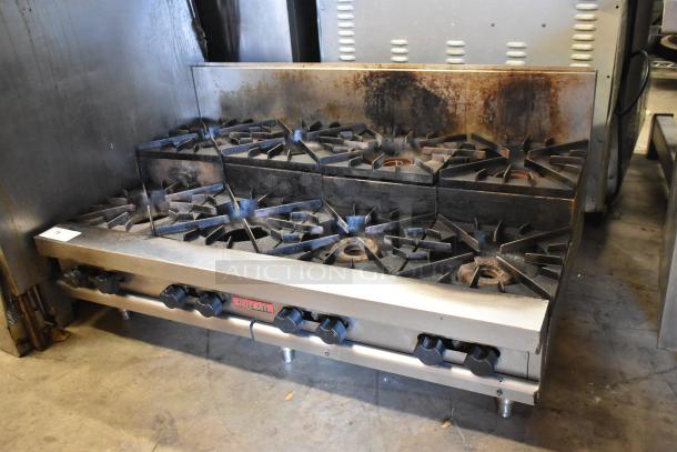 Vulcan stainless steel gas-powered 2-tier, 8-burner commercial range. Well-used condition with visible wear.