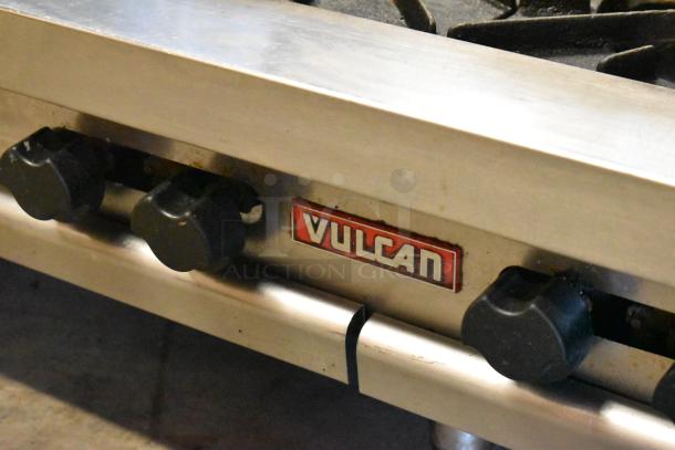 Vulcan stainless steel commercial countertop gas range, 2 tier, 8 burners, visible Vulcan logo, in used condition.