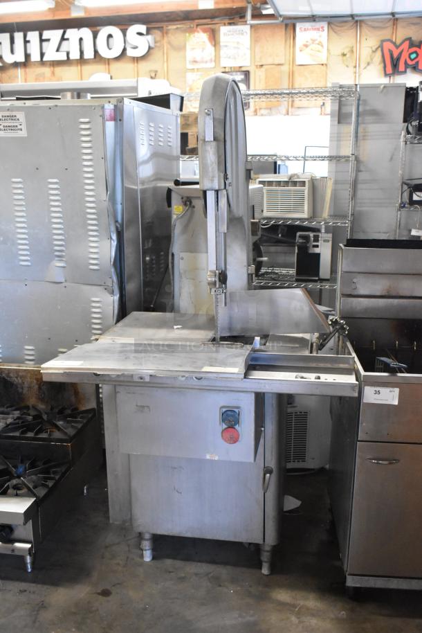 Metal commercial floor-style meat saw, 208/240 volts, 3 phase. Features sturdy stainless steel body, safety switch visible.