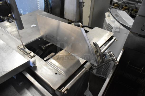 Metal commercial floor-style meat saw, 208/240V, 3-phase. Features adjustable blade, sturdy metal frame, well-maintained condition.