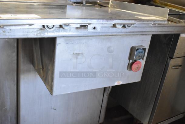 Metal commercial floor-style meat saw, 208/240 volts, 3 phase. Features push-button operation and sturdy construction. Good condition.