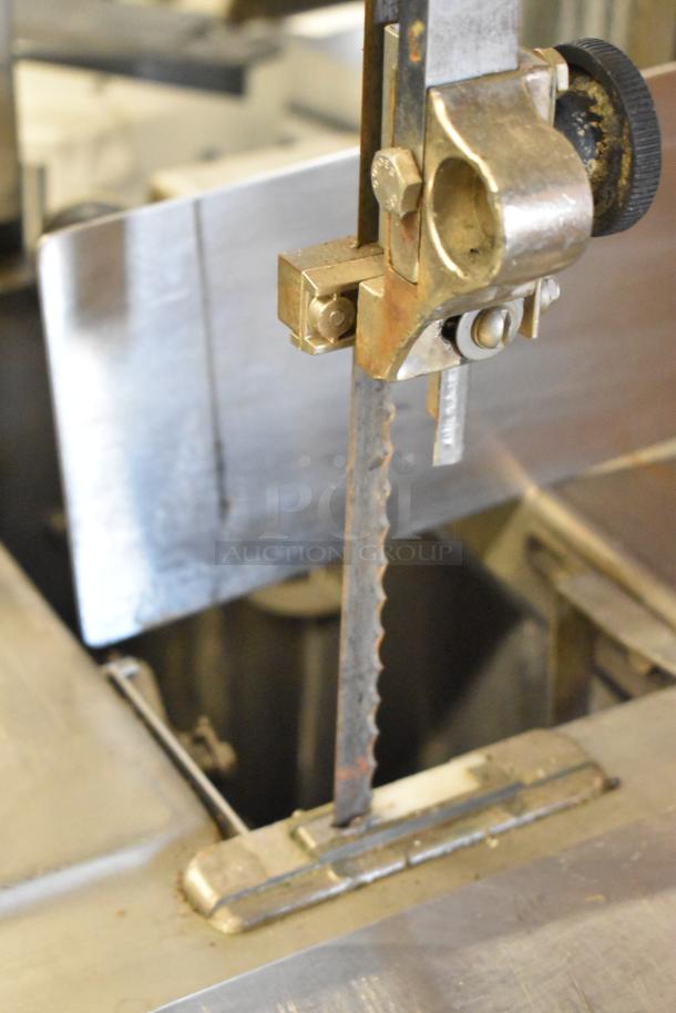 Metal commercial floor-style meat saw, 208/240 volts, 3-phase, visible blade and metal components, used condition.