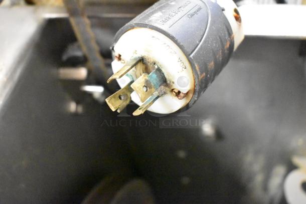 Metal commercial floor-style meat saw with 208/240 volts, 3-phase plug. Features visible wear and signs of use.