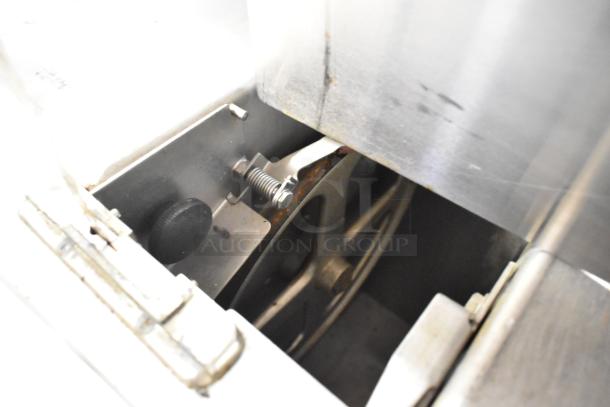 Metal commercial floor style meat saw, 208/240 volts, 3 phase. Features a durable metal construction with visible blade and adjustment mechanics.