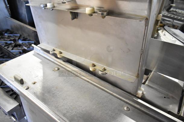 Metal commercial floor-style meat saw, robust build, 208/240 volts, 3-phase. Visible markings indicate durable condition.