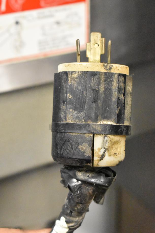 Worn electrical plug for Varimixer W60P dough mixer, indicating 208V, 3-phase use. Dirty tape wrapped at base.