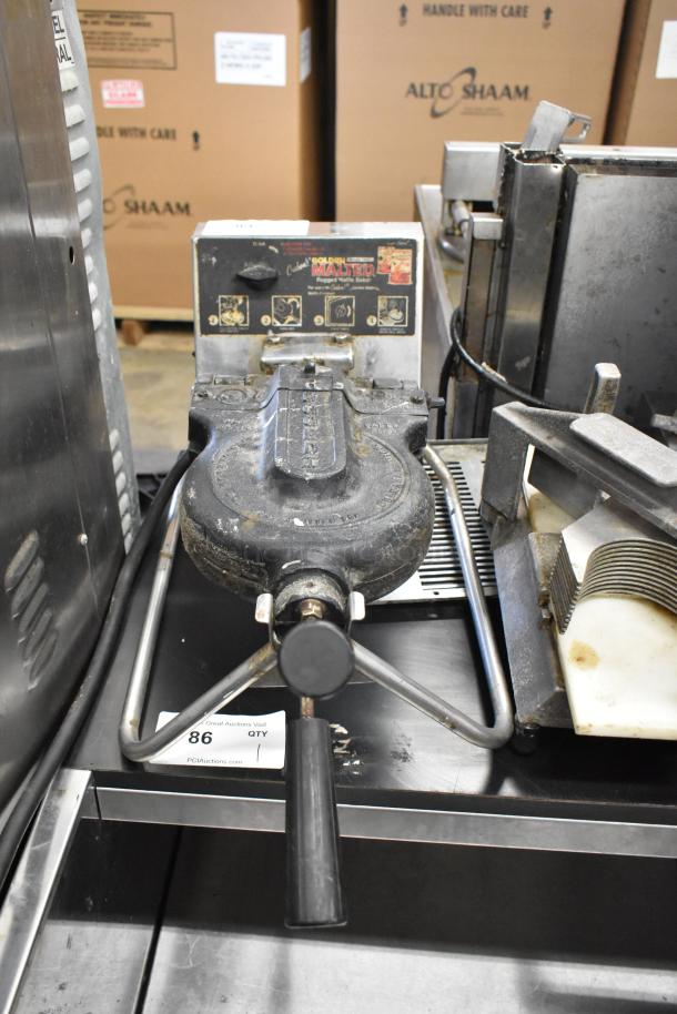 Metal commercial countertop waffle maker, 115 volts, 1 phase. Visible wear with maintenance labels. Rugged build.