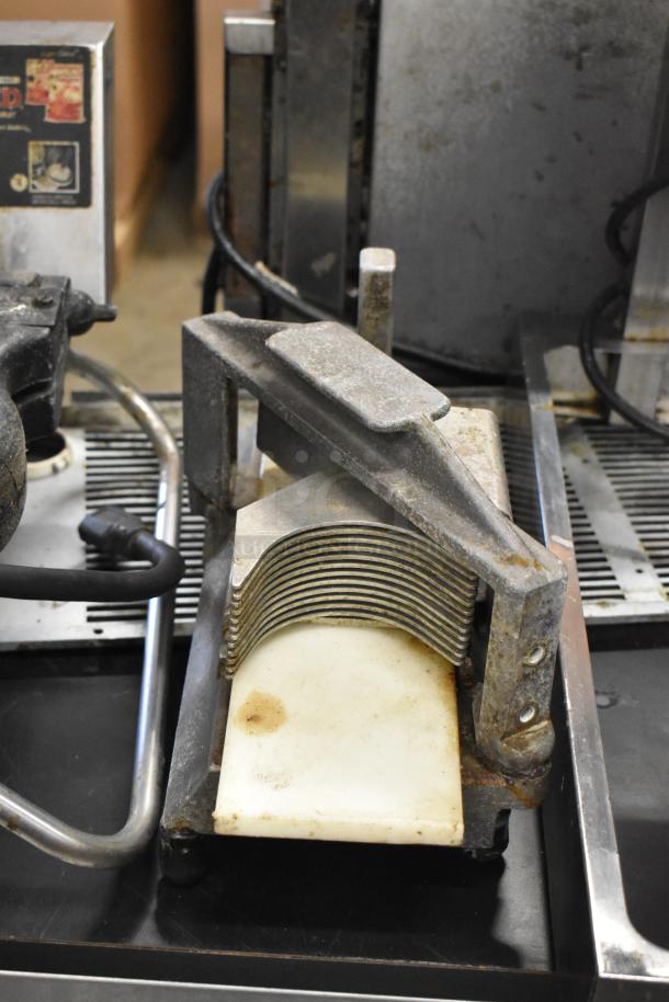 Nemco Tomato Slicer, manual operation, metal frame, used condition with visible wear, includes additional unidentified item.