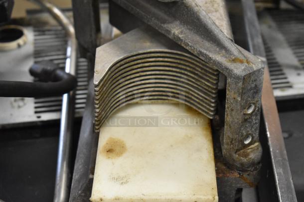 Nemco Tomato Slicer, features multiple blades and a white cutting board. Shows signs of use with visible rust.