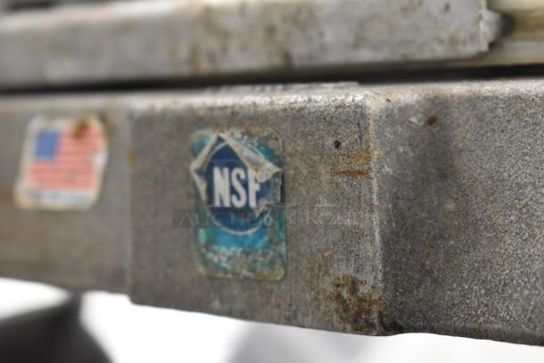 NSF-certified Nemco Tomato Slicer, metal surface, minor rust visible, includes U.S. label, condition noted.