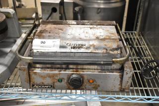 Adcraft SG-811 metal countertop panini press, 120 volts, showing signs of rust and wear. Includes caution hot label.