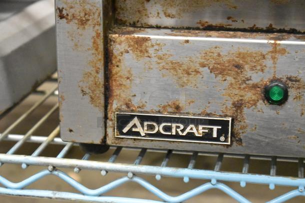 Adcraft SG-811 Metal Panini Press, countertop model, showing signs of rust. Green indicator light, Adcraft logo visible.