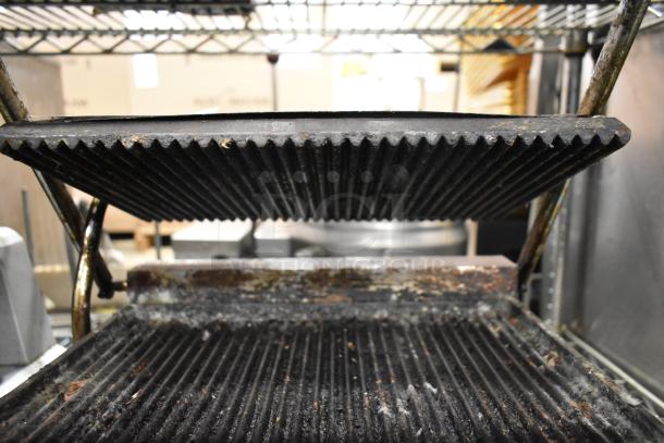 Adcraft SG-811 Metal Panini Press, 120 Volts, showing wear on grooved plates, ideal for countertop use in restaurants.