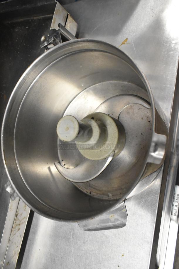 Metal food processor bowl with S blade attachment, showing signs of use. Includes dough hook and scissors.