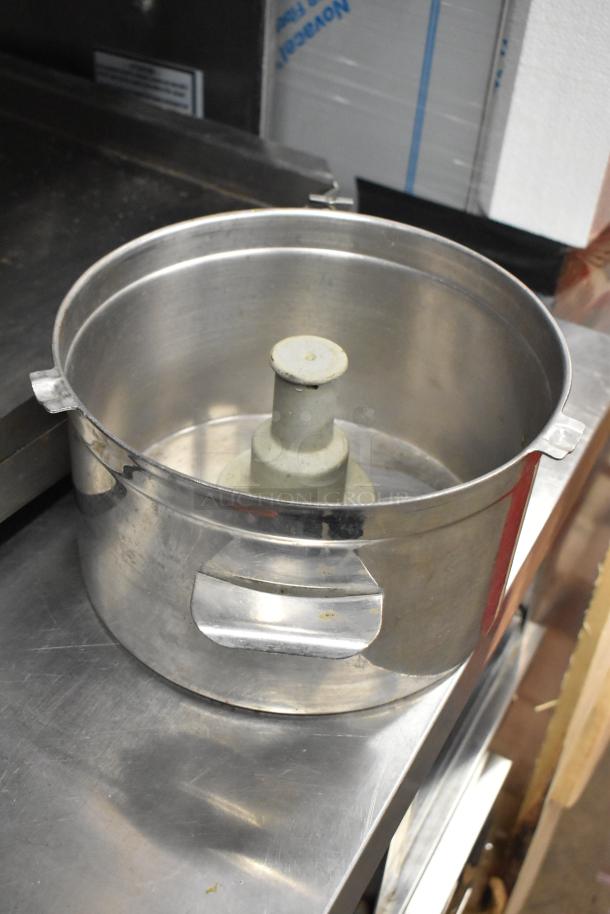 Metal food processor bowl with center attachment slot, includes S blade, dough hook, and scissors, in good condition.