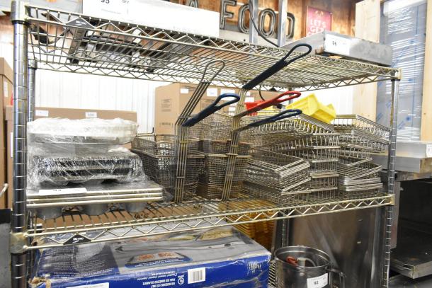 Metal fry baskets and muffin baking pans on a Metro shelving unit. Items appear wrapped and in good condition.