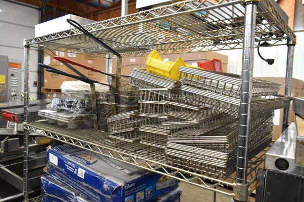Metal wire shelving holds assorted metal fry baskets and muffin baking pans, visible tags. Various kitchen items included.