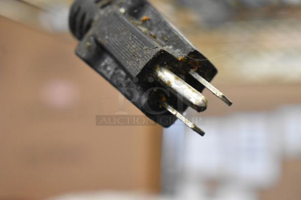 A close-up of a metal prong from an Avantco Metal Countertop Warmer. 120 Volts, 1 Phase. Condition appears used.