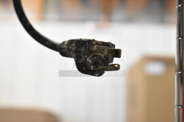 Power plug of Avantco 177FFDS1 Metal Countertop Warmer, 120 volts, visible wear, detail of electrical connection.