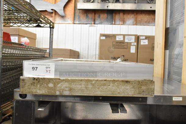 Two shadowboxes, slightly worn, do not lock. Sale includes two boxes per bid. Featured in warehouse setting.