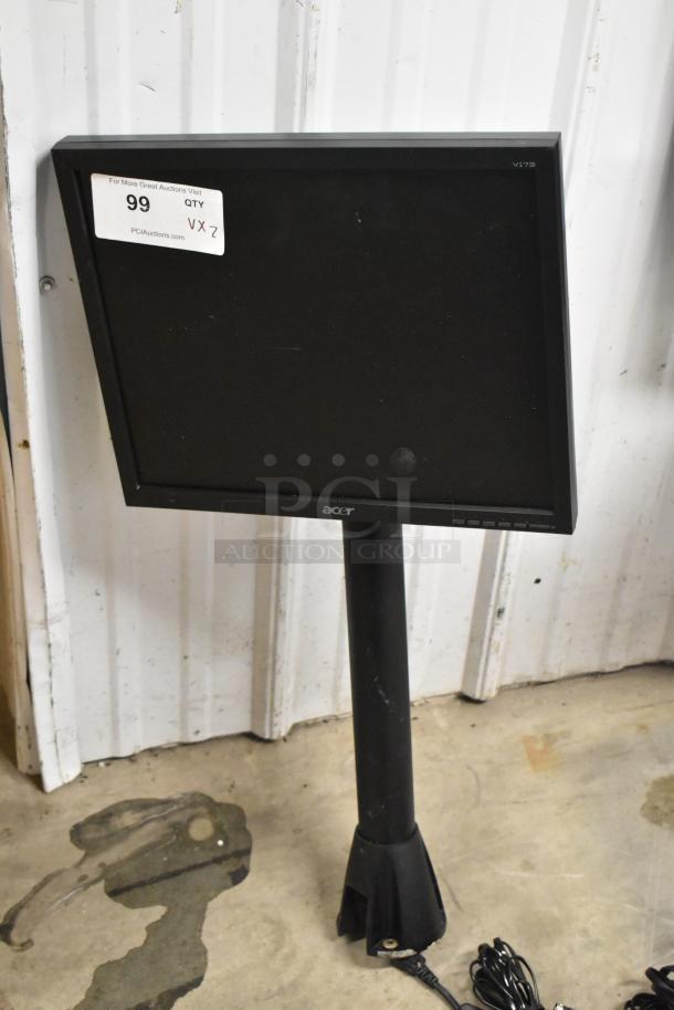 Two Acer V173 monitors in used condition with stands. Auction tag visible, indicating quantity and bidding information.