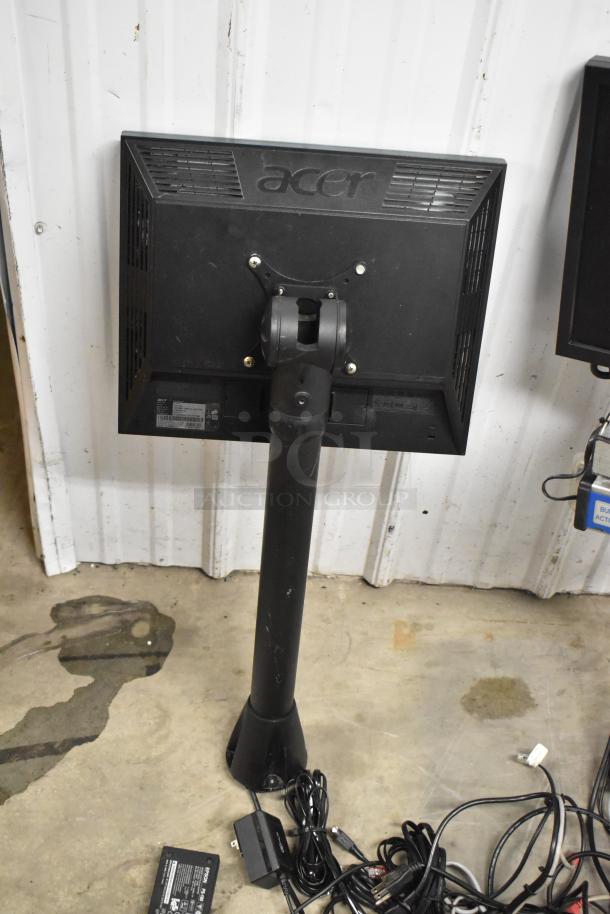 Two Acer V173 monitors on a stand. Includes cables and power adapters. Back view, featuring model labels. Appears in good condition.