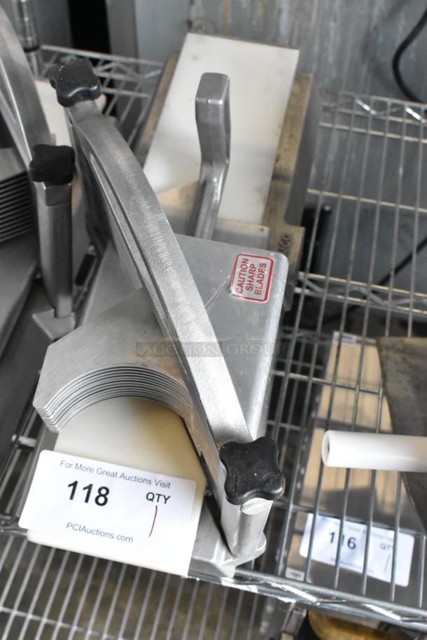 Nemco 56600 Metal Countertop Tomato Slicer with sharp blades warning label, in good condition, on a wire rack.