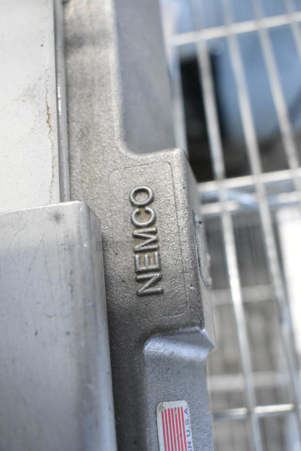 Nemco 56600 Metal Countertop Tomato Slicer, durable stainless steel, visible Nemco brand marking, "Made in USA" label.