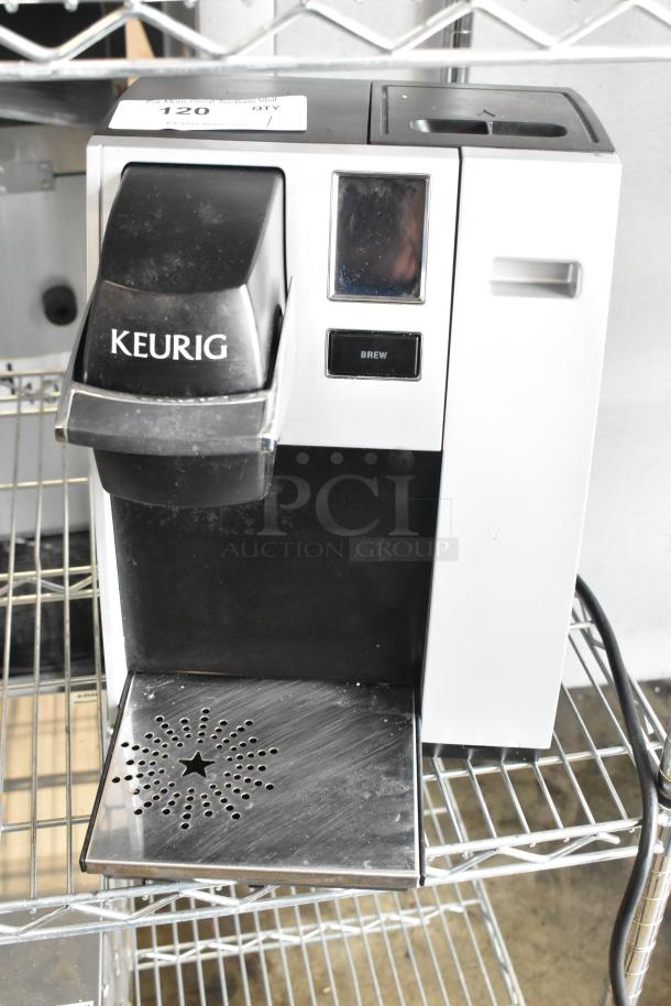Keurig K150 countertop coffee machine, single cup model, 120 volts, used condition, brew button visible.