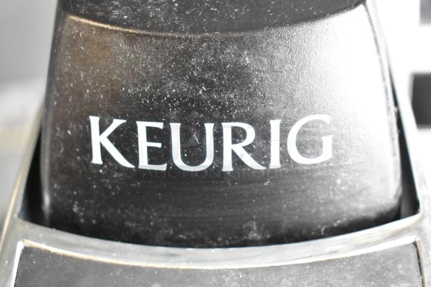 Keurig K150 single cup coffee machine, black, used condition, 120 volts, countertop model, distinct Keurig logo.