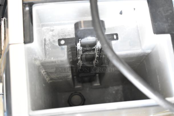 Keurig K150 countertop single cup coffee machine, inside reservoir view, shows signs of use. 120 volts, 1 phase.