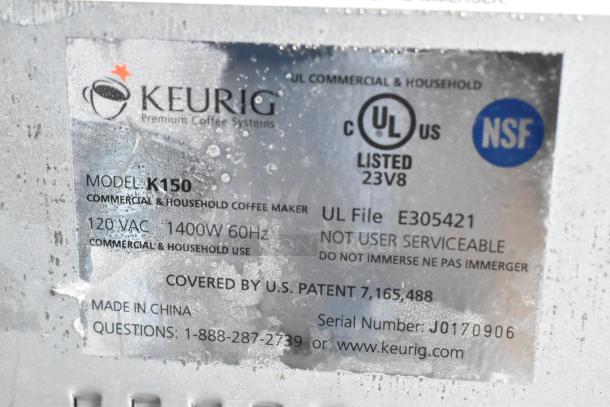 Label on Keurig K150 coffee machine showing model, 120V, 1400W, commercial use, UL and NSF listed, made in China.