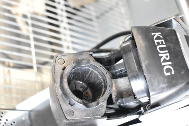 Keurig K150 Countertop Single Cup Coffee Machine, showing coffee pod holder. Model K150, 120 volts, 1 phase.