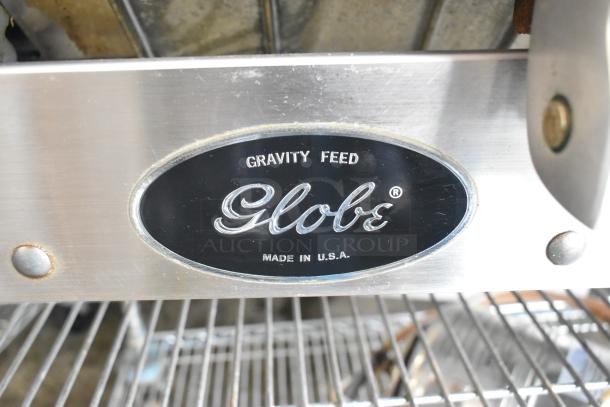Globe stainless steel commercial meat slicer, Gravity Feed model, 115V, 1 phase, made in USA, in used condition.
