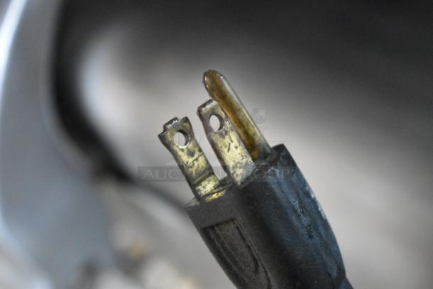 Close-up of the power plug for a Globe Stainless Steel Commercial Countertop Meat Slicer. Shows standard wear.