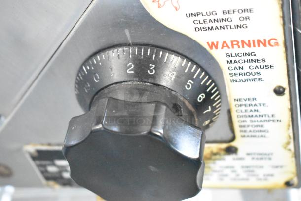 Globe stainless steel meat slicer control knob with warning labels, 115 volts, 1 phase, commercial countertop model.