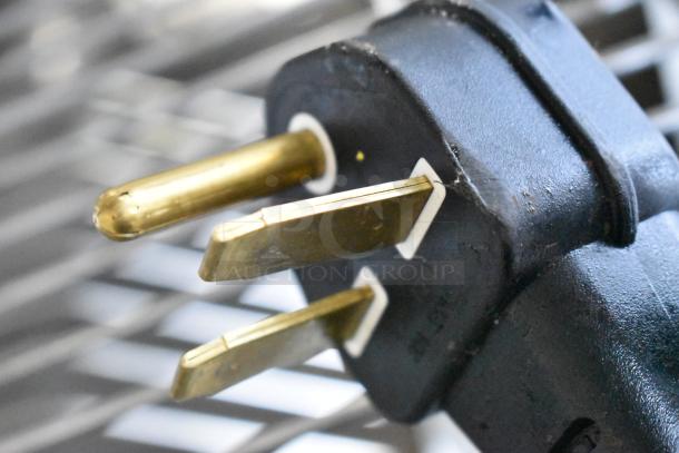 Close-up of a plug for the Hatco ITQ-1750-2C commercial toaster, 208V, 1 Phase, highlighting metal prongs.