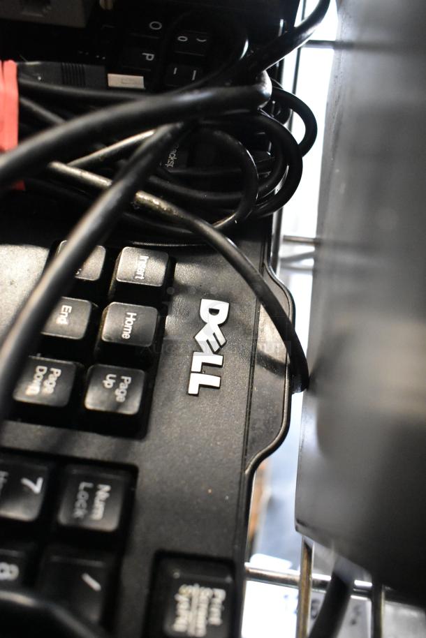 Dell computer keyboard under tangled cables, part of a POS system including ViewSonic monitor, Epson printers, Verifone reader.