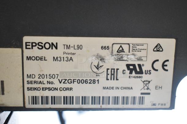 Label on Epson TM-L90 printer, Model M313A, showing serial number VZGF006281, manufacturing info, and compliance logos.