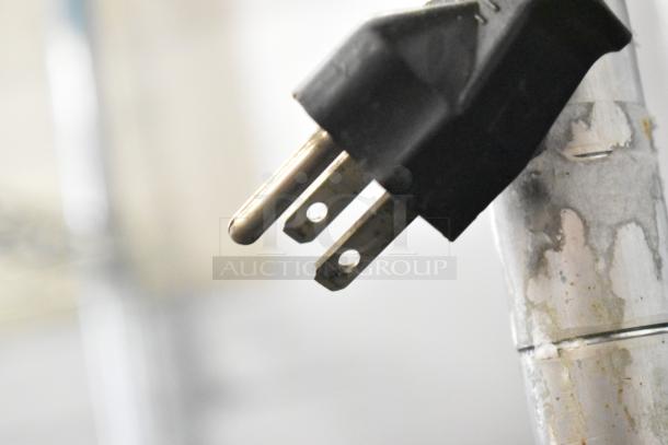 Close-up of a black power plug, part of the Nuova Simonelli MDX Metal Commercial Espresso Grinder. 115 Volts, 1 Phase.