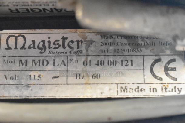 Magister M MD LA espresso grinder label showing model, 115 volts, CE mark, and "Made in Italy" text.