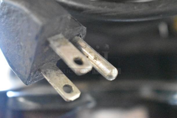 Close-up of power plug for a metal commercial countertop espresso bean grinder, 115 volts, 1 phase.