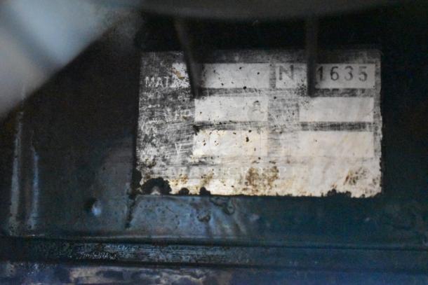 Metal commercial countertop espresso bean grinder, 115 volts, 1 phase, visible wear and markings partially visible.