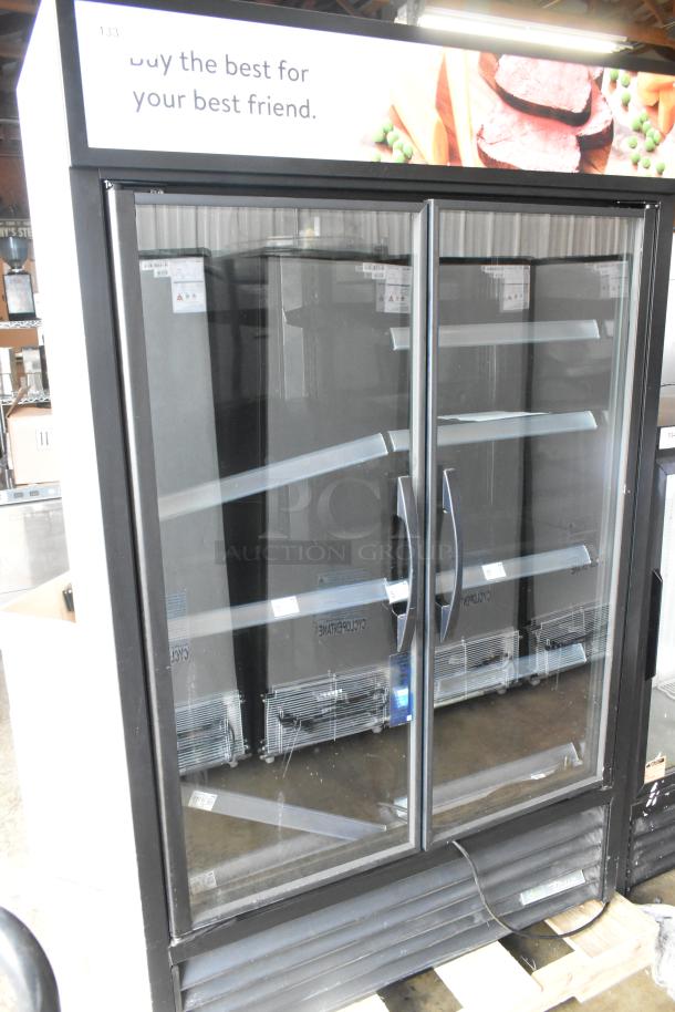 2022 True TVM-48SL-HC 2 Door Reach-In Cooler Merchandiser with metal racks. Excellent condition. 115V, 1 Phase.