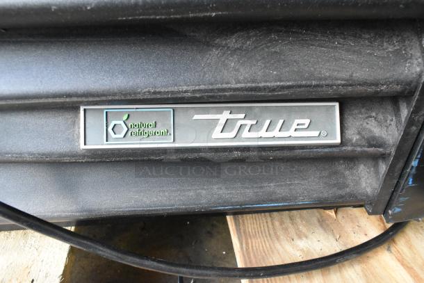 2022 True TVM-48SL-HC Cooler; metal racks, 115V, natural refrigerant label, excellent condition, durable commercial use.