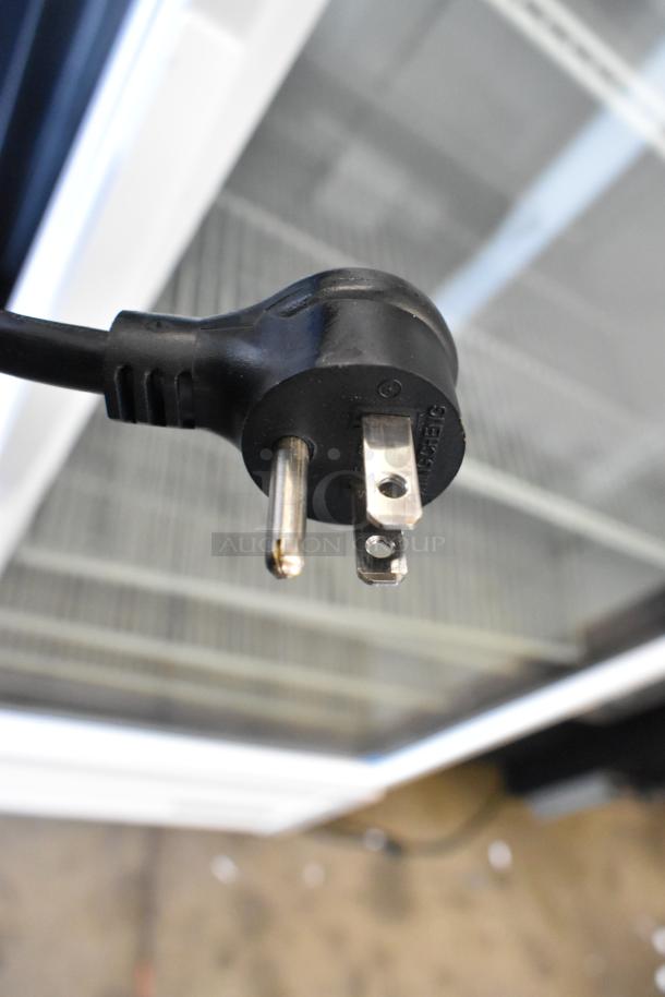 Close-up of the plug for a True TSCI-600R-G-PH commercial cooler merchandiser, featuring a durable black three-prong design.