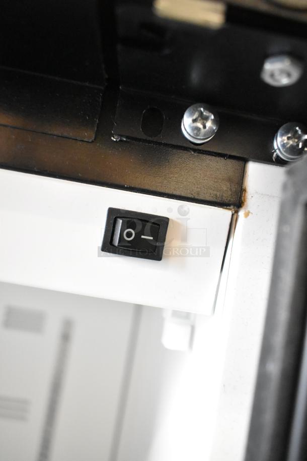 Close-up of the power switch on a 2019 Habco SE18 commercial cooler. Visible details include screws and casing.