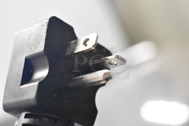 Close-up of a power plug for Avantco 193MAC48HCB Commercial Merchandiser, 115V, 1 Phase, highlighting prongs and condition.