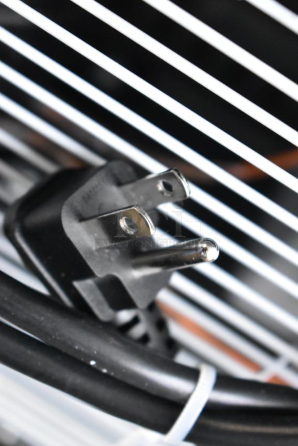 Close-up of a KoolMore KM-MDR-1GD-10C commercial display refrigerator power cord, showing pronged plug and cable.